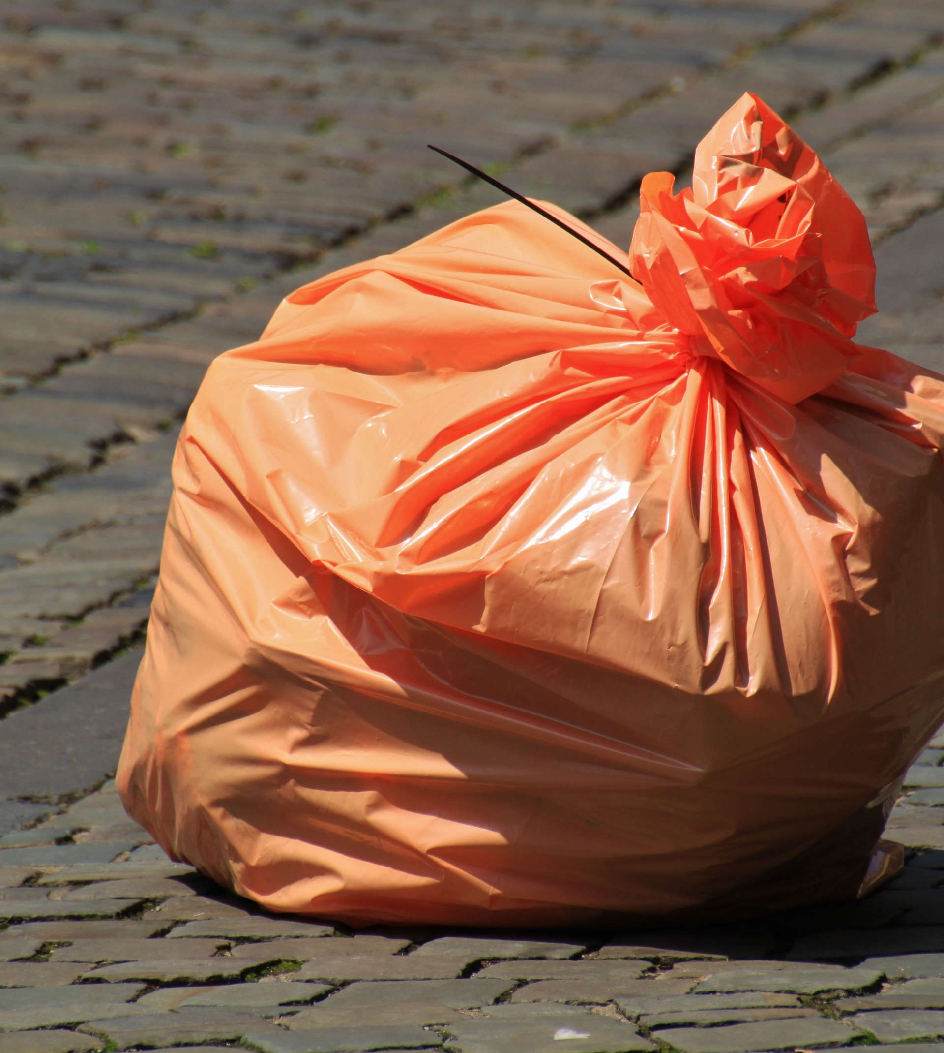 An orange rubbish bag made of polyethene